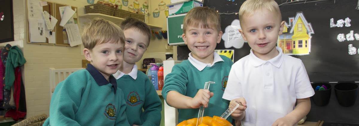 happy boys hollowing a pumpkin